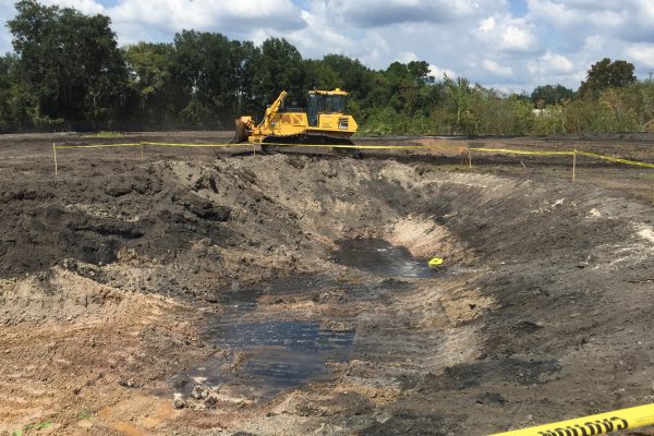 photo of an excavation area with a bulldozer in the background