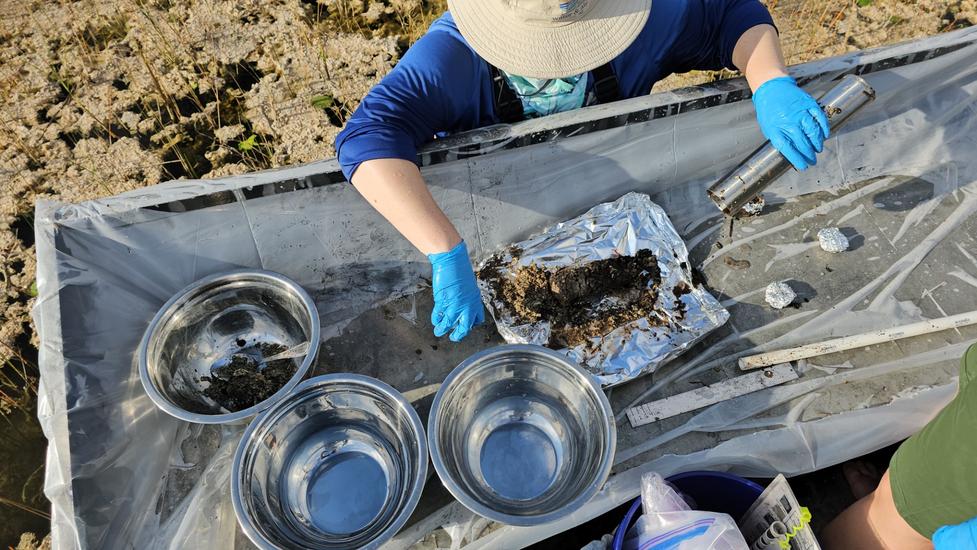 photo of a worker collecting a core sample from the everglades