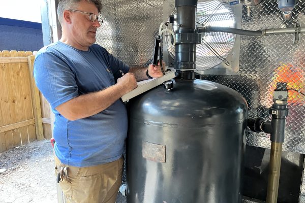 photo of a technician collecting field notes at a remediation site